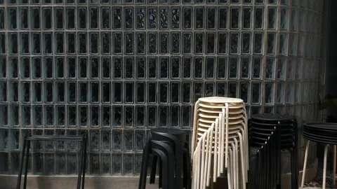 Stacked stools in a restaurant interior, modern furniture storage, organiza.. Stock Footage 345197939