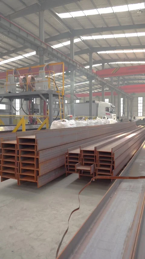 Stacked Structural Steel I-Beams Stored in Modern Metal Fabrication Factory Stock Footage 339384573