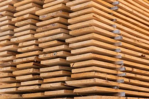 Stacked timber planks for construction and lumber industry Stock Photos
