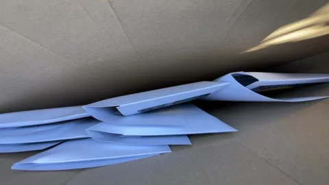 Stacked white padded mailers inside corrugated box from low interior viewpoint Stock Footage 345660198
