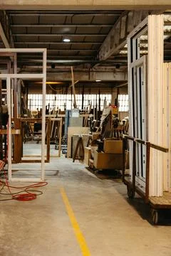 Stacked window frames inside metal carpentry workshop Stock Photos