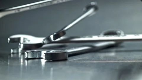 Stacked wrenches and spanners with reflective highlights Filmed on a high-speed Stock Footage 335411573