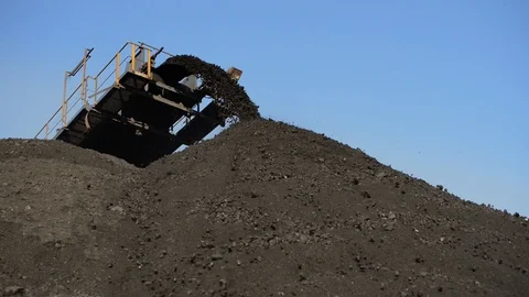 Stacker empties coal for storage at a port warehouse Video stock 117433298