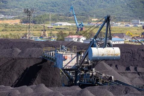 Stacker-reclaimer during loading and unloading of coal.  Stock Photos