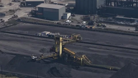 Stacker reclaimer machine moving coal in a stockyard Stock Footage 340963376