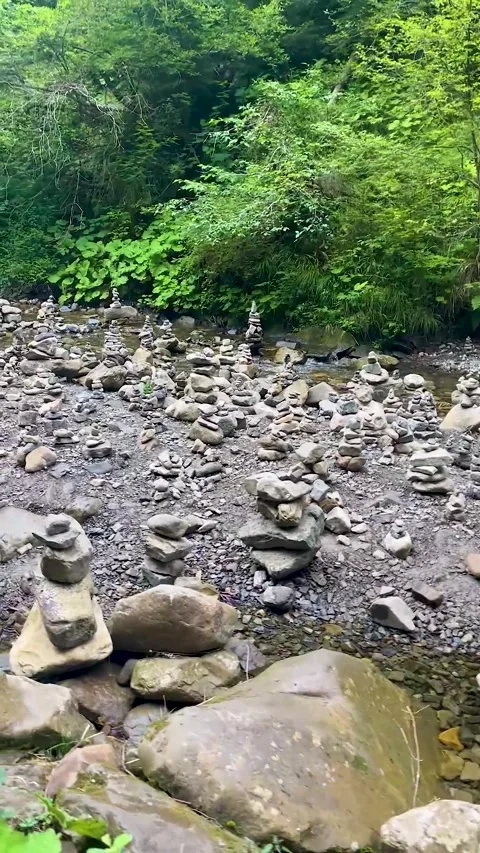 Stacking balance. balancing stacks of zen stones on a river in the Carpathian  Stock Footage 249001783