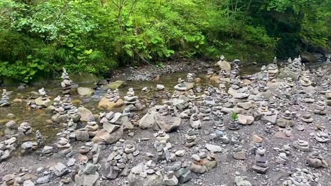 Stacking balance. balancing stacks of zen stones on a river in the Carpathian Stock Footage 249001830