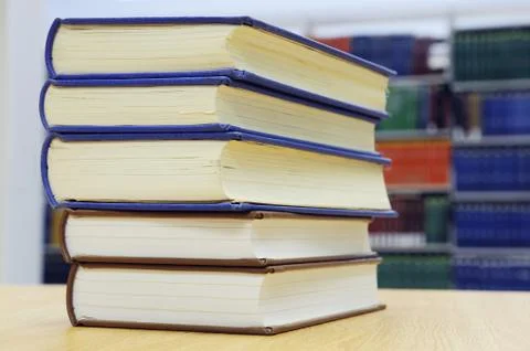 Stacking books on library desk Stock Photos