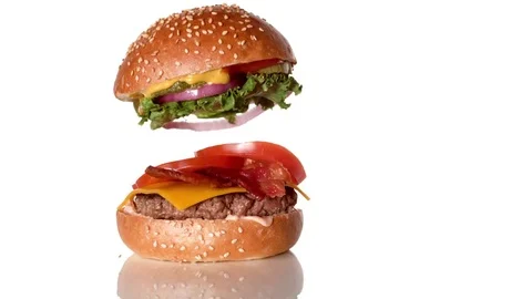 Stacking burger and a glass of beer. Slow Motion. Stock Footage 73946706