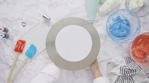 Stacking cake layers to create the round three-layer vanilla cake. Stock Footage 115389622