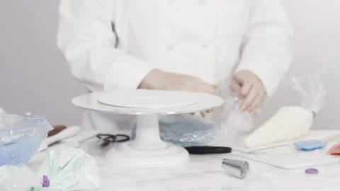 Stacking cake layers to create the round three-layer vanilla cake. Stock Footage 141353382