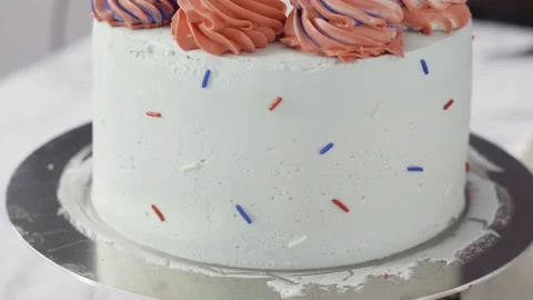 Stacking cake layers to create the round three-layer vanilla cake. Stock Footage 143583543