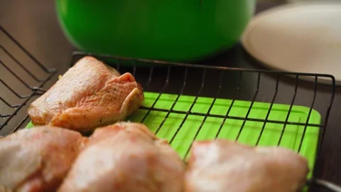 Stacking chicken thighs on a barbecue grill, close-up Stock Footage 308581277