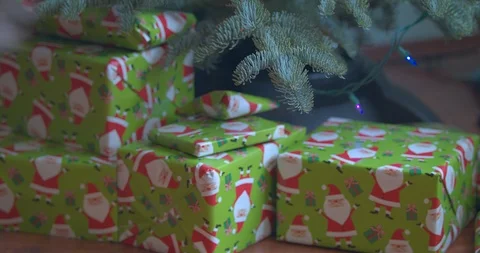 Stacking Christmas Presents Under the Tree Stock Footage 100799758