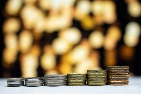 Stacking of coin isolated on bokeh background. Copy space. Business concept. Stock Photos