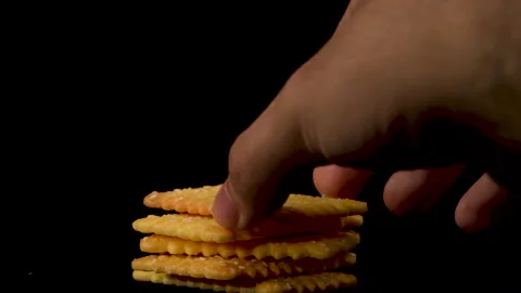 Stacking crackers , medium close up , black background Stock-Footage 135778001