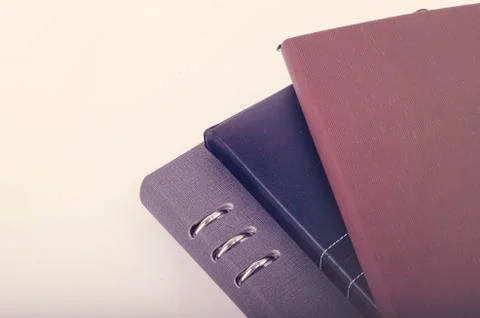 Stacking diaries on white background. negative space for text Stock-Fotos