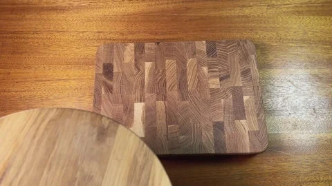 Stacking different natural oak and bamboo cutting boards on table Stock Footage 342276664