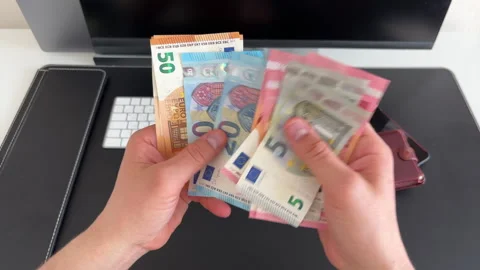 Stacking Euro Bills in Front of Computer Screen Video stock 308287326