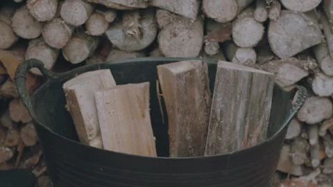 Stacking firewood to basket Stock Footage 267840726