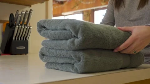 Stacking folded and laundered towels. Stock Footage 334280044