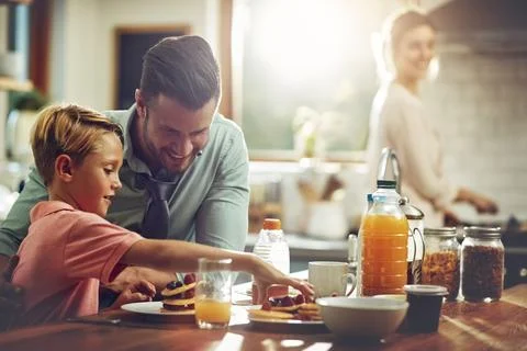 Stacking up the good stuff. a man sitting with his son while hes having Stock Photos