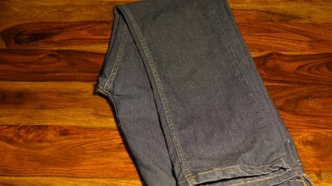 Stacking jeans on the table Video stock 128201270