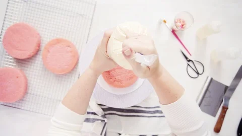 Stacking layers together of pink birthday cake. Stock Footage 97750190