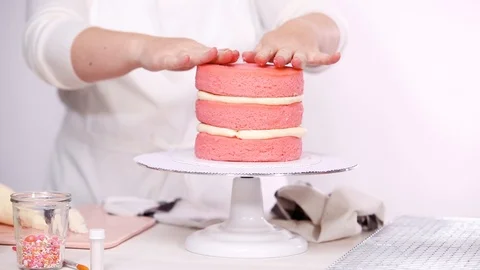 Stacking layers together of pink birthday cake. Stock Footage 97751027