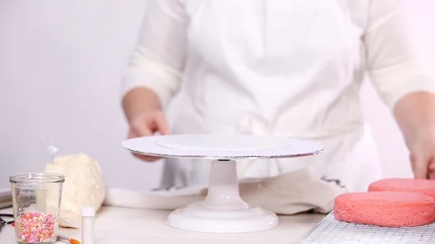 Stacking layers together of pink birthday cake. Stock Footage 97751078