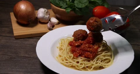 Stacking meatball on sauce cooked spaghetti white plate with ingredients roma Stock Footage 156836919