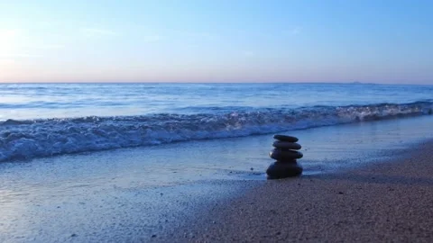 Stacking pebbles on the shore. 4K Stock Footage 195653545