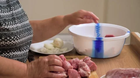 Stacking pork cubes on wooden board for kebab preparation. Arranging raw meat Stock Footage 319160962