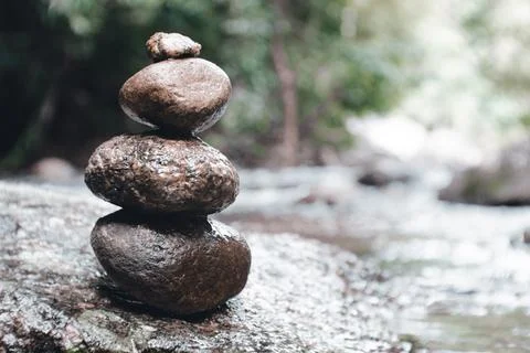 Stacking rocks on the lake or river in nature. Stock Photos