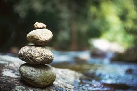 Stacking rocks on the lake or river in nature. Stock Photos