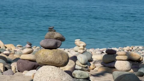 Stacking rocks together to make cairns  Stock Footage 294748218