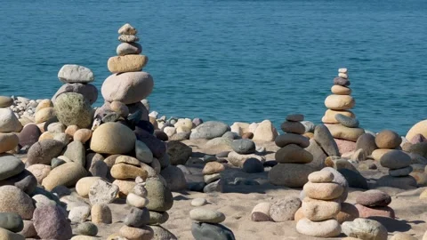 Stacking rocks together to make cairns  Stock Footage 294748251