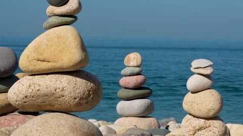 Stacking rocks together to make cairns Stock Footage 295000654