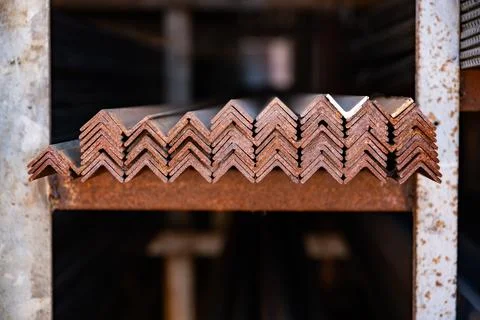 Stacking rusty metal angle bars, preparing for construction and industrial Фото