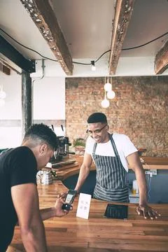 Stacking up the sales one snap at a time. a man using a smartphone to make a Foto stock