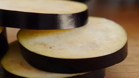 Stacking Slices of Fresh Eggplant Stock Footage 125115308