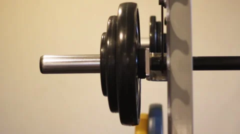Stacking some weights on a barbell before workout Stock Footage 51324179