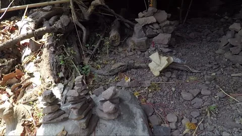 Stacking Stones in Mountain Cave with Offering, Vat Phou Temple Complex, Laos Stock Footage 279252891