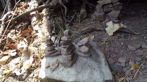 Stacking Stones in Mountain Cave with Offering, Vat Phou Temple Complex, Laos Stock Footage 279252897