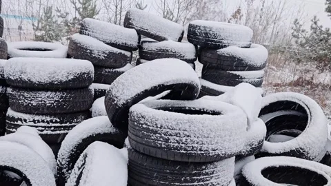 Stacking used car tires covered with fresh snow outdoors Stock Footage 325092775