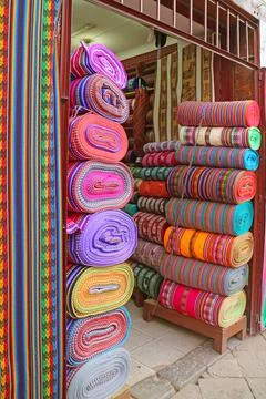 Stacks of Amazing Multi-colored Peruvian fabric rolls for sale in downtown Cusco Stock Photos