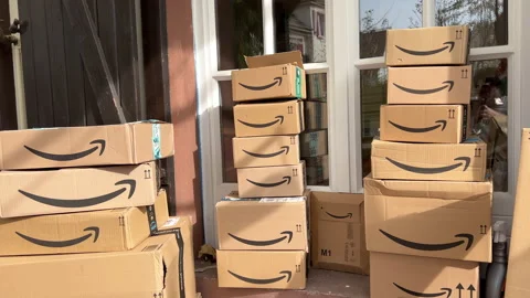 Stacks of Amazon Prime packages delivered to a home doors Stock Footage 221257732