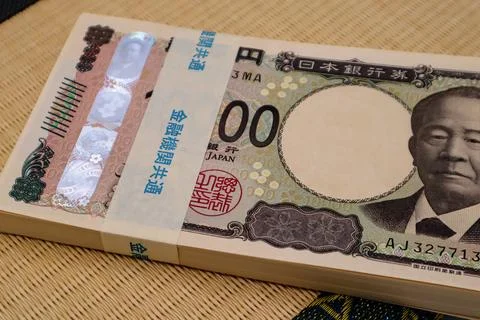 Stacks of banknotes on the tatami mat. Stock Photos