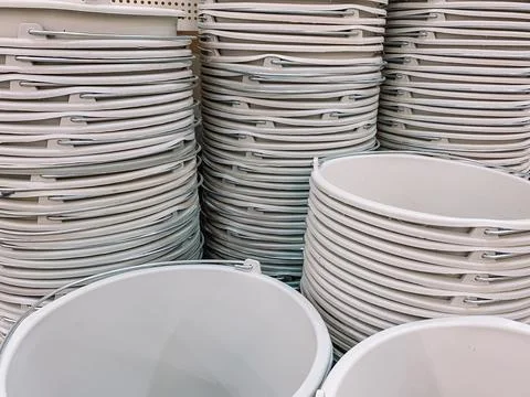 Stacks of beige plastic buckets Stock Photos