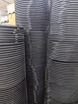 Stacks of black plastic materials ready for various uses Фото